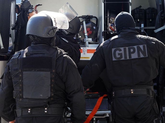 Policemen of the GIPN (French national police internvention groups) get ready to leave after searching a building as part of an anti-terrorist operation, on October 6, 2012 in Cannes, southeastern France. The anti-terror operation is conducted in several cities around France, notably in Strasbourg where a man was shot and fatally wounded while being arrested