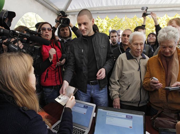 epa03439955 Left Front opposition movement leader Sergei Udaltsov (C) votes at the polling station during elections of a 45-member Coordinating Committee in Moscow, Russia, 20 October 2012. The rally in support of the elections in the opposition coordinating council held in Moscow was attended by less than 500 people. EPA