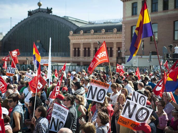-, SPAIN : Members and supporters of the CCOO Workers Union and the General Union of Workers (UGT) take part in a protest organized by Unions against the Spanish government's austerity policies at the Atocha Square in the centre of Madrid on October 7, 2012. Thousands joined a protest march in the Spanish capital today against the conservative government's austerity policies amid growing uncertainty over whether the country will need a financial bailout. AFP