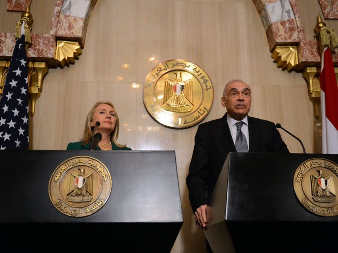Egyptian Foreign Minister Mohammed Kamel Amr (R) and US Secretary of State Hillary Clinton give a statement after their meeting with President Mohamed Morsi in the presidential palace in Cairo on November 21, 2012. Amr announced that a truce had been agreed between Israel and Hamas to end a week of bloodshed in and around Gaza and said a ceasefire would take effect at 1900 GMT