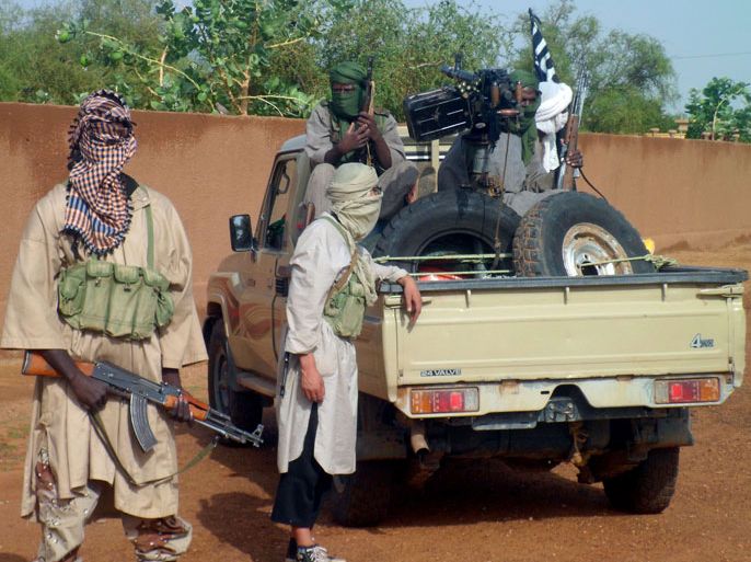 FILES) This file picture taken on August 7, 2012 shows fighters of the Ansar Dine Islamic group standing in Kidal. Ansar Dine, one of the armed Islamist groups occupying northern Mali, said on November 14, 2012 it was no longer seeking to impose strict sharia law across the entire country, but still wanted to keep it in its stronghold of Kidal. AFP PHOTO / ROMARIC OLLO HIEN
