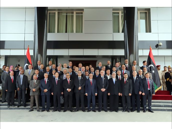 Ali Zaidan, prime minister of the Interim Government (6th L) and former Libya's prime minister Abdurrahim el-Keib (7th L) pose with other members of the new government for a group photograph during the final handover ceremony between the transitional Libyan government and the Libyan interim government, on November 18, 2012, at the headquarters of the Prime Minister's Office in the capital Tripoli. AFP PHOTO/MAHMUD TURKIA