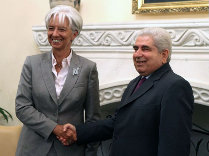 epa03396911 Cypriot President Demetris Christofias (R) shake hands with Christine Lagarde (L), Managing Director of the International Monetary Fund, during their meeting at the Presidential Palace in Nicosia, Cyprus, 13 September 2012. Lagarde visits Cyprus at the invitation of the Eurogroup. EPA/KATIA CHRISTODOULOU