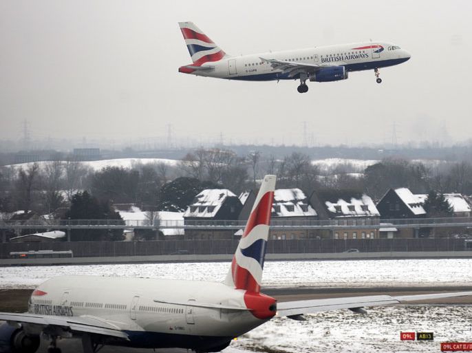 A British Airways aircraft taxi's on to the runway in preparation for take off while another comes in to land at Heathrow Airport in London, Britain, 21 December 2010. Thousands of passengers remain stranded across Britain. Heathrow has been criticized for the length of time it took to clear tons of snow from runways and plane stands, but the government has revealed that an offer of Army assistance was turned down. Heathrow plans to have its second runway open 21 December. EPA/ANDY RAIN