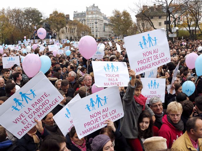 Protesters hold placards and balloons during a demonstration to denounce the same-sex marriage on November 17, 2012 in Paris. France's Socialist government on November 7, 2012 adopted a draft law to authorise gay marriage and adoption despite fierce opposition from the Roman Catholic Church and the right-wing opposition