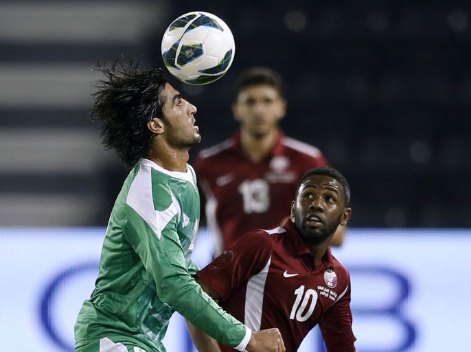 Qatar's Khalfan Ibrahim (R) fights for the ball with Iraq's Ahmed Ibrahim Khalaf during their international friendly soccer match in Doha November 7, 2012. REUTERS/Fadi Al-Assaad (QATAR - Tags: SPORT SOCCER)