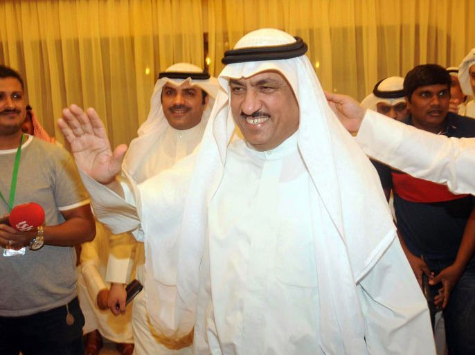 Former Kuwaiti opposition MP Musallam al-Barrak (C) waves to supporters as he was arrested at his residence in the Al-Andalus district of Kuwait City on October 29, 2012, on accusations that he made public remarks deemed offensive to Emir Sheikh Sabah al-Ahmad al-Sabah, who cannot be criticised under the constitution