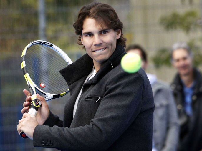 epa03489495 Spanish tennis player Rafael Nadal attends the opening of the 100th tennis playground of the Richard Krajicek Foundation in Rotterdam, The Netherlands, 28 November 2012. With the playgrounds the foundation of the former Dutch tennis player offers a place to play tennis for the underprivileged children in run-down suburbs. EPA/BAS CZERWINSKI