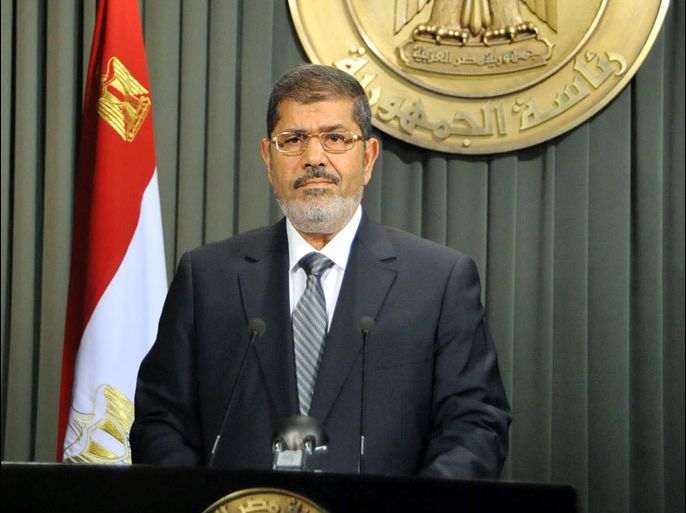 A hand out picture released by Egyptian Presidency shows Egyptian President Mohamed Morsi giving a televised speech on December 26, 2012, after signing into law a contentious constitution he and Islamist allies backed to the fury of the opposition and to international concern. Morsi said he would shuffle his government to tackle pressing economic problems, in his national address during which he hailed a new constitution backed by his Islamist allies. AFP PHOTO/HO/EGYPTIAN PRESIDENCY == RESTRICTED TO EDITORIAL USE - MANDATORY CREDIT "AFP PHOTO / HO / EGYPTIAN PRESIDENCY" - NO MARKETING NO ADVERTISING CAMPAIGNS - DISTRIBUTED AS A SERVICE TO CLIENTS ==