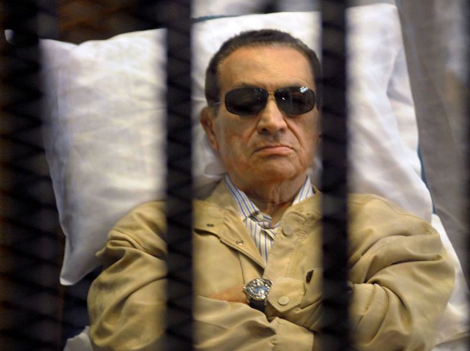 -- AFP PICTURES OF THE YEAR 2012 -- Ousted Egyptian president Hosni Mubarak sits inside a cage in a courtroom during his verdict hearing in Cairo on June 2, 2012. A judge sentenced Mubarak to life in prison after convicting him of involvement in the murder of protesters during the uprising that ousted him last year. AFP PHOTO/STR