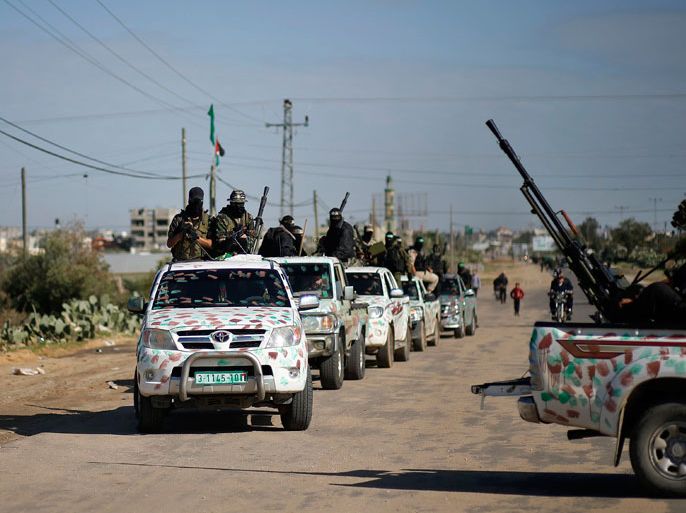 Palestinian members of the al-Qassam brigades, the armed wing of the Hamas movement, ride in pickup trucks as they await the arrival of Hamas chief Khaled Meshaal in Rafah in the southern Gaza Strip December 7, 2012. Hamas's exiled leader Meshaal will step onto Palestinian land for the first time in 45 years on Friday for a "victory rally" in the Gaza Strip, displaying his newfound confidence after last month's conflict with Israel. Meshaal, the Islamist group's leader