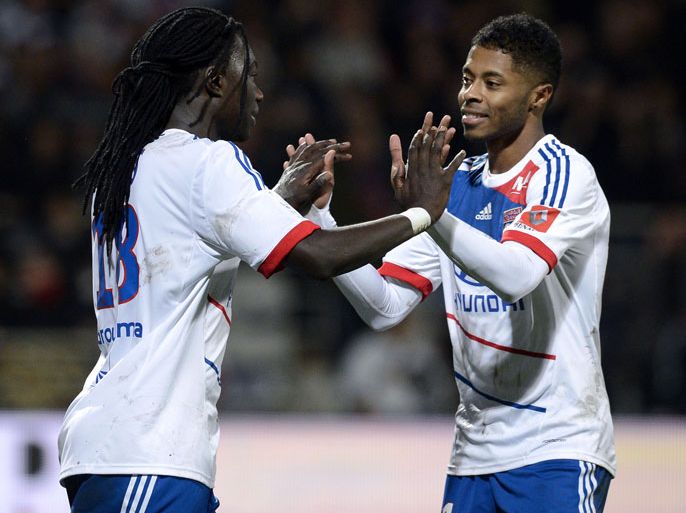 Lyon's French forward Bafetimbi Gomis (L) is congratulated by his teammate Lyon's Brazilian midfielder Michel Fernandes Bastos, after he scored a goal during the French L1 football match Lyon vs Nice, on December 22, 2012 at the Gerland stadium in Lyon, central eastern France. AFP PHOTO / PHILIPPE MERLE
