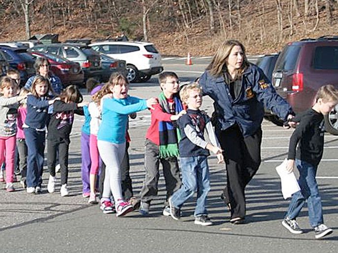 epa03508811 Police officers evacuate children from the Sandy Hook Elementary School in Newtown, Connecticut, USA, 14 December 2012 following a school shooting. Multiple deaths were reported in a shooting at a US elementary school in Connecticut. CBS News said 27 people were dead, including 14 children. ABC News reported 12 deaths at the Sandy Hook Elementary school in Newtown. President Barack Obama had been informed and was getting regular updates on the situation, the White House said. A person believed to be the shooter was among the dead, the Hartford Courant newspaper reported. The school principal and a school psychiatrist were also killed, CNN said. EPA/SHANNON HICKS / NEWTOWN BEE / HANDOUT HANDOUT EDITORIAL USE ONLY/NO SALES