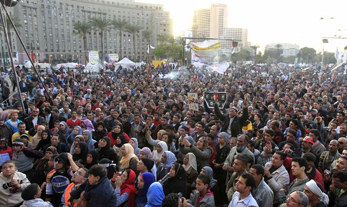 r : Anti-Mursi protesters chant anti-government slogans at Tahrir Square in Cairo December 11, 2012. Nine people were hurt when gunmen fired at protesters camping in Cairo's Tahrir Square on Tuesday, according to witnesses and the Egyptian media, as the opposition called for a major demonstration it hopes will force President Mohamed Mursi to postpone a referendum on a new constitution. REUTERS/Mohamed Abd El Ghany (EGYPT - Tags: POLITICS CIVIL UNREST)