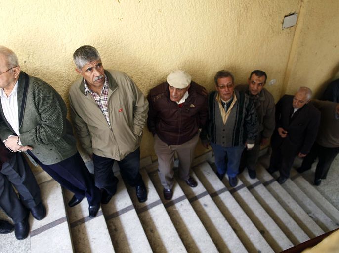 Egyptian men queue to cast their vote in a referendum on a new constitution at a polling station in central Cairo on December 15, 2012. Egypt's opposition cried fraud in the first round of a divisive referendum on a new constitution, accusing President Mohamed Morsi's Muslim Brotherhood of rigging votes to adopt the Islamist-backed text