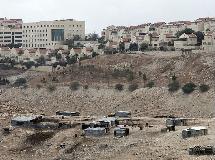 : A Bedouin camp is seen near the Israeli settlement of Maale Adumim (background) in the occupied West Bank on the outskirts of Jerusalem on December 5, 2012. If Israel moves ahead with settlement construction in a sensitive strip of West Bank land near Jerusalem it will mean the end of the peace process, Palestinian negotiator Saeb Erakat told AFP. AFP PHOTO/AHMAD GHARABLI
