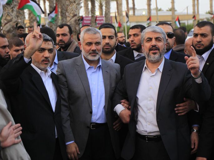 afp : Hamas leader in exile Khaled Meshaal (R) waves goodbye while standing next to Hamas prime minister in the Gaza Strip Ismail Haniya (C) and Hamas leader Izzat al-Rishq (L), upon his departure from the Gaza Strip on December 10, 2012 in Rafah, on the border with Egypt. Exiled Hamas chief Khaled Meshaal left Gaza after a historic first visit to the tiny Palestinian enclave. AFP PHOTO/ SAID KHATIB