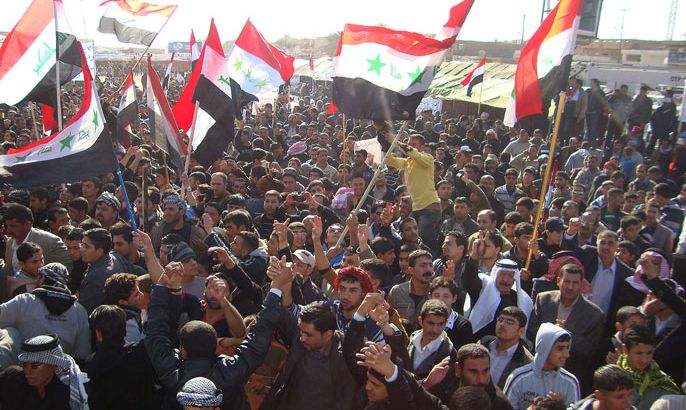 Iraqis wave their national flag during a sit-in by citizens, clergy, tribal leaders and MPs, in the northern city of Samarra, in Salaheddin province, close to the Razzaq central mosque on December 31, 2012. The Iraqi authorities called for an end to what a senior official said were illegal and illegitimate protest rallies in Sunni-majority provinces including Salaheddin, Nineveh and Anbar, that have cut key trade routes
