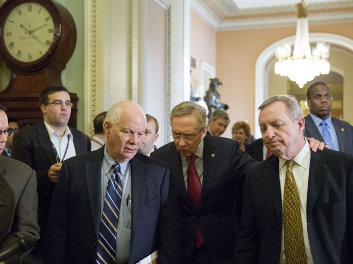 : WASHINGTON, DC - DECEMBER 28: Majority Leader Harry Reid (D-NV) (C) is flanked Sen. Ben Cardin (D-MD) (L) and Sen. Dick Durbin (D-IL) (R) as they leave a caucus meeting and head toward the Senate floor on Capitol Hill on December 28, 2012 in Washington, DC. Senators were back on Capitol Hill on Friday to try to deal with the "fiscal cliff" before the year-end deadline