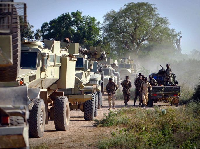 epa03505920 A handout photograph released by the African Union-United Nations Information Support Team on 12 December 2012, shows soldiers of the Somali National Army (SNA) dismount from a fighting vehicle alongside an armoured colomn of the African Union Mission in Somalia (AMISOM) in the town of Jawahar in Middle Shabelle region north of the Somali capital Mogadisu, 10 December. Somali National Army (SNA) forces supported by the African Union Mission in Somalia (AMISOM) captured the town of Jawahar, 90km north of Mogadishu, on 09 December from the Al-Qaeda-affiliated extremist group Al Shabaab.Jawahar was one of the last remaining urban areas under the Shabaab's control who have lost large swathes of territory and major towns across Somalia over the last 18 months following sustained security operations against them by combined SNA and AMISOM forces. EPA/AU-UN IST/ HANDOUT HANDOUT EDITORIAL USE ONLY/NO SALES