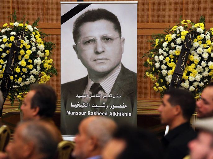 LYB11 - Tripoli, -, LIBYA : Mourners listen as the President of the General National Congress of Libya, Mohammed Megaryef (unseen), speaks during a memorial service for leading Libyan dissident, Mansour Rashid al-Kikhia (portrait), in Tripoli on December 2, 2012. Kikhia, who disappeared 19 years ago under the Kadhafi regime,