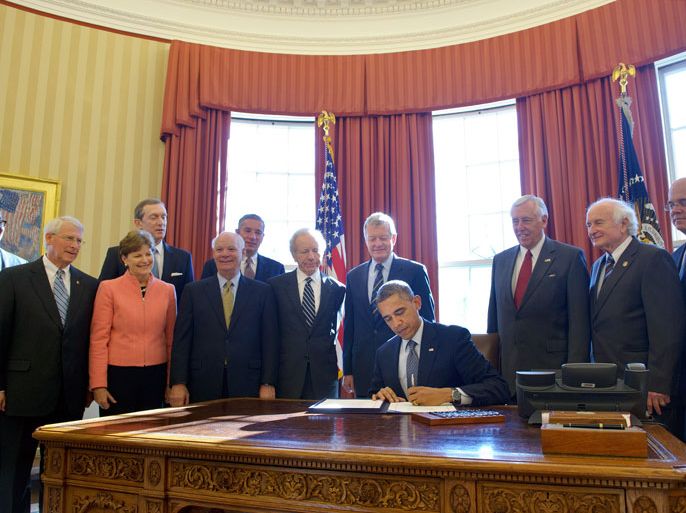 Washington, District of Columbia, UNITED STATES : US President Barack Obama signs H.R. 6156, the Russia and Moldova Jackson-Vanik Repeal and Sergei Magnitsky Rule of Law Accountability Act, on December 14, 2012 in the Oval Office of the White House in Washington, DC. The legislation would punish officials tied to the November 2009 death of lawyer and anti-corruption activist Sergei Magnitsky in a Moscow detention centre, denying them entry to the US and freezing their assets. Looking on from left are: US Trade Representative Ron Kirk, Senator Roger Wicker, R-MS, Senator Jeanne Shaheen, D-NH, Mark Levin, Executive Director of NCSJ, Senator Ben Cardin, D-MD, Klaus Kleinfeld, Chairman and CEO, Alcoa Inc., Senator Joe Lieberman, I-CT, Senate Finance Committee Chairman Sen. Max Baucus, D-MT, Democratic Whip Rep. Steny Hoyer, D-MD, House Ways and Means Committee Ranking Member Rep. Sandy Levin, D-MI, and Representative Jim McGovern, D-MA. AFP PHOTO/Mandel NGAN
