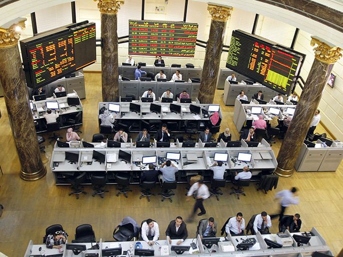 FILE - In this Wednesday, Oct. 29, 2008 file photo, Egyptian brokers work during a session at the Egyptian stock market in Cairo, Egypt. Egypt's benchmark stock index on Sunday plunged by more than 9.5 percent in the first trading session since the country's Islamist president issued decrees to assume sweeping new powers, while police in central Cairo fired tear gas at protesters who accuse the Egyptian leader of a blatant power grab.