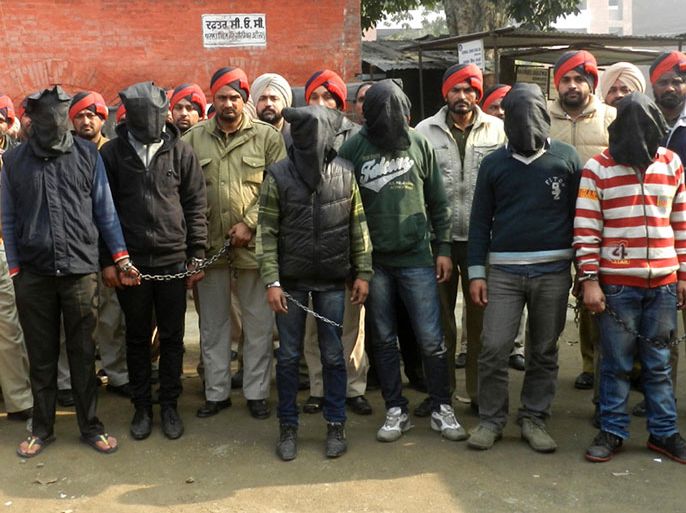 police personnel present six arrested men, accused of a gang rape in Punjab state, for an appearance at court in Gurdaspur on Januray 13, 2013. Six men have been arrested over the rape of a passenger on a coach in India, police said, weeks after the gang-rape and murder of a student on a bus in New Delhi sparked nationwide protests. AFP PHOTO/STR