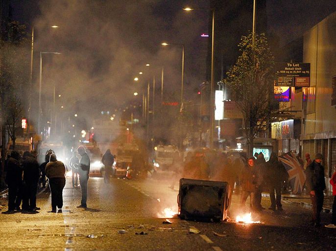 Burning debris blocks the Newtownards Road in east Belfast January 5, 2013. Violent protests flared in Northern Ireland on Saturday as loyalists renewed their anger against restrictions on flying Britain's union flag from Belfast City Hall. REUTERS/Cathal McNaughton (NORTHERN IRELAND - Tags: POLITICS CIVIL UNREST)