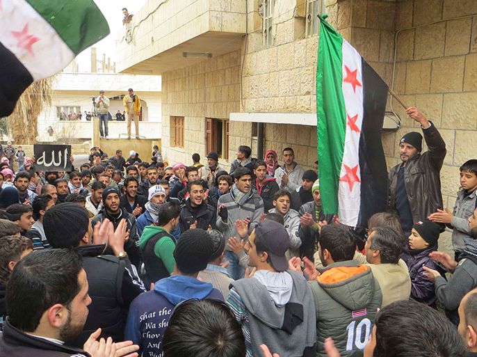 Demonstrators wave Syrian opposition flags during a protest against Syria's President Bashar al-Assad, in Al-Balad district, Deraa, in this picture provided by Shaam News Network and taken January 11, 2013. Picture taken January 11, 2013. REUTERS/Ali Abu Salah/Shaam News Network/Handout (SYRIA - Tags: POLITICS CIVIL UNREST) ATTENTION EDITORS - THIS PICTURE WAS PROVIDED BY A THIRD PARTY. REUTERS IS UNABLE TO INDEPENDENTLY VERIFY THE AUTHENTICITY, CONTENT, LOCATION OR DATE OF THIS IMAGE. FOR EDITORIAL USE ONLY. NOT FOR SALE FOR MARKETING OR ADVERTISING CAMPAIGNS. THIS PICTURE IS DISTRIBUTED EXACTLY AS RECEIVED BY REUTERS, AS A SERVICE TO CLIENTS