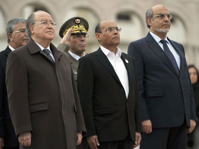 Tunisian President Moncef Marzouki (C), Tunisian Parliament Speaker Mustapha Ben Jaafar (L) and Prime Minister Hamadi Jebali (R) review troops during an official ceremony marking the second anniversary of the uprising that ousted long-time dictator Zine El Abidine Ben Ali on January 14, 2013 in Tunis. A deadlock over a new constitution and the growing influence of radical Islamists are further challenges facing the nation since Ben Ali fled to Saudi Arabia. AFP PHOTO / FETHI BELAID