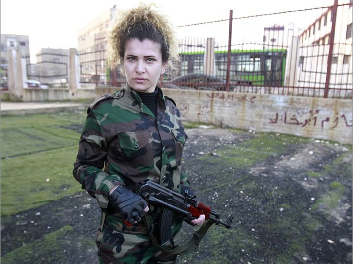 A Syrian National Defense force woman who just finished training, holds a rifle at the training center in Wadi al-Dahab in the Syrian city of Homs, on January 21, 2013. Some 500 women are being trained and will help other National Defence force recruits at checkpoints and with other security tasks. AFP PHOTO/ANWAR AMRO (Photo credit should read ANWAR AMRO/AFP/Getty Images)