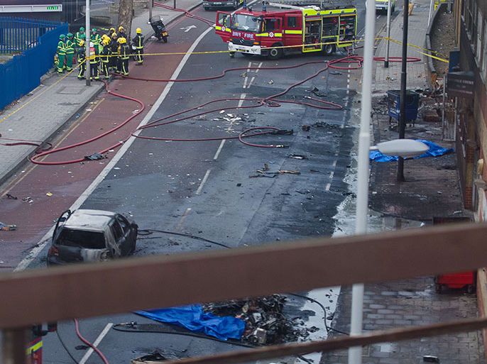 Debris and a burned out car are pictured at the scene of a helicopter crash in central London, on January 16, 2013