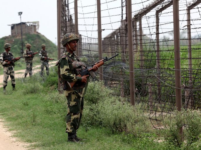 In this photograph taken on August 2, 2012 Indian Border Security Force (BSF) soldiers stand guard along fencing near the India-Pakistan Chachwal border outpost, some 65 kms north from the north-eastern Indian city of Jammu. Pakistani troops January 8, 2013 killed two Indian soldiers near the tense disputed border in Kashmir, two Indian military sources said, two days after Islamabad said one of its soldiers was killed there