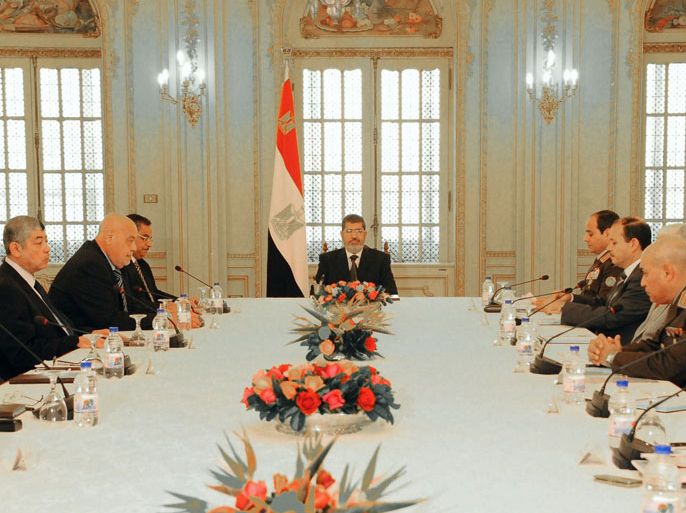 This handout picture released by the Egyptian Presidency shows Egypt's President Mohamed Morsi (C) during his meeting with the national defense council in Cairo on January 26, 2013.