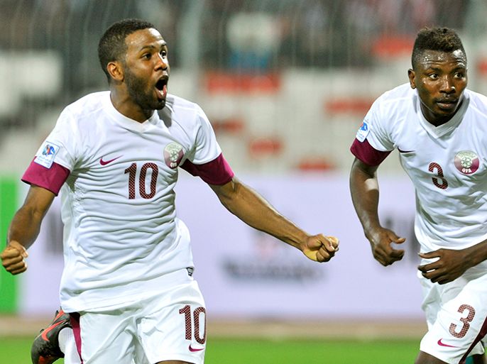 Qatar's Khalfan Ibrahim (L) celebrates his goal with teammate Kasola Mohammed during their Gulf Cup tournament soccer match against Oman at Isa Sports City in Isa Town January 8, 2013. REUTERS/Tariq AlAli (BAHRAIN - Tags: SPORT SOCCER)