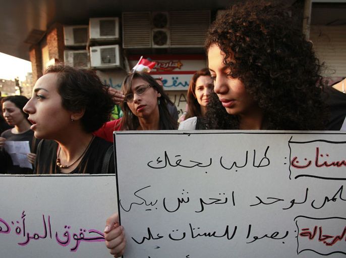 epa03255685 Egyptian women hold placards calling for the end of sexual harassment on women who take part in demonstrations at a protest on Tahrir square, in Cairo, Egypt, 08 June 2012. According to local media reports on 08 June, human rights organizations made a call for stronger positions against 'inteniona' harassment of women during protests. Demonstrators gathered on 08 June on Cairo's Tahrir Square, focal point of the Egyptian revolution of 2011, for a mass protest demanding the exclusion of Hosny Mubarak’s last premier, Ahmed Shafiq, from a presidential run-off vote with Muslim Brotherhood candidate Mohamed Morsi on June 16-17. EPA/ANDRE PAIN