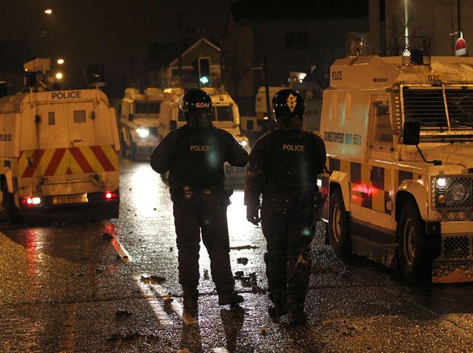afp/Police in armoured vehicles secure the area in Carrickfergus, near Belfast in County Antrim, Northern Ireland on January 11, 2013 after a Loyalist demostration as part of an ongoing campaign opposing Belfast City