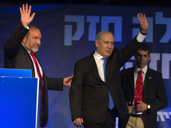 Israeli Prime Minister Benjamin Netanyahu (C) and ultra-nationalist Avigdor Lieberman (L) of the Likud-Beitenu coalition wave to supporters at the party headquarters in Tel Aviv early on January 23, 2013 after their Likud-Beitenu list won the Israeli general elections. Netanyahu said it was necessary to form the "broadest possible government" after his Likud-Beitenu list won a narrow election victory, with the centrist Yesh Atid in second place