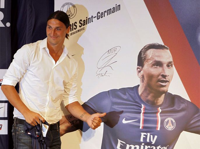 Zlatan Ibrahimovic of Sweden, newly-signed player for French soccer club Paris St Germain, poses beside a poster of himself after a news conference in Paris July 18, 2012. Big-spending Paris St Germain aim to dominate Ligue 1 this season and showed their intent by signing Sweden captain Zlatan Ibrahimovic from AC Milan on a three-year deal on Wednesday. "Sweden international Zlatan Ibrahimovic, 30, has been transferred from AC Milan and signed a three-year deal in favour of Paris Saint-Germain," PSG said on their website.