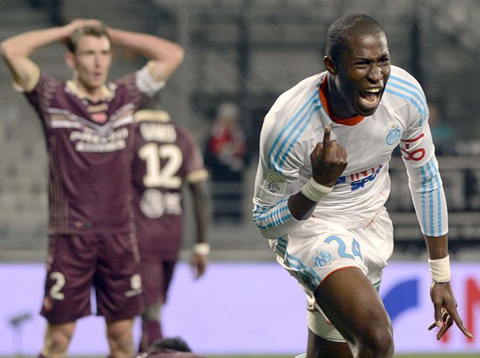 Marseille's French defender Rod Fanni (R) reacts after scoring a goal during the French L1 football match Marseille vs Valenciennes on February 16, 2013 at the Velodrome stadium in Marseille, southern France. AFP PHOTO / ANNE-CHRISTINE POUJOULAT