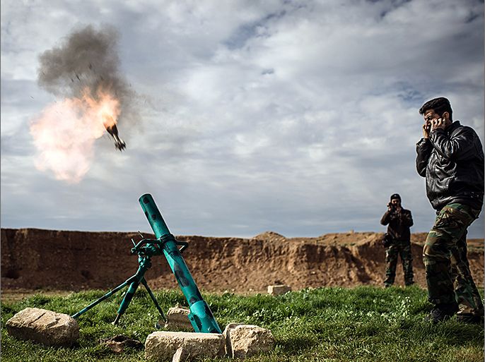 TOPSHOTS Syrian rebels fire a mortar towards regime forces stationed at Kwiriss airport in Al-Bab, 30 kilometres from the northeastern Syrian city of Aleppo, on February 14, 2013. Syrian Foreign Minister Walid al-Muallem and opposition National Coalition chief Ahmed Moaz al-Khatib will make separate visits to Moscow for talks in the coming weeks, a top Russian diplomat said. AFP PHOTO / ELIAS EDOUARD