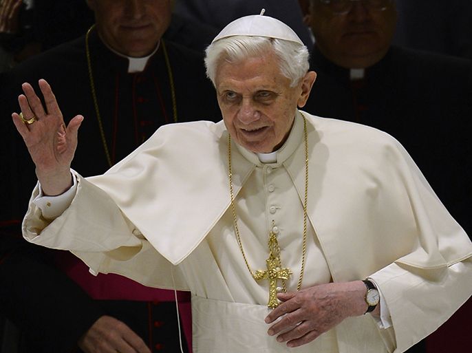 Pope Benedict XVI waves as he arrives for his weekly general audience on February 13, 2013 at the Paul VI hall at the Vatican. Pope Benedict XVI made his first public appearance Wednesday since the shock announcement of his resignation, sticking with his schedule by presiding over his weekly general audience. AFP PHOTO / FILIPPO MONTEFORTE