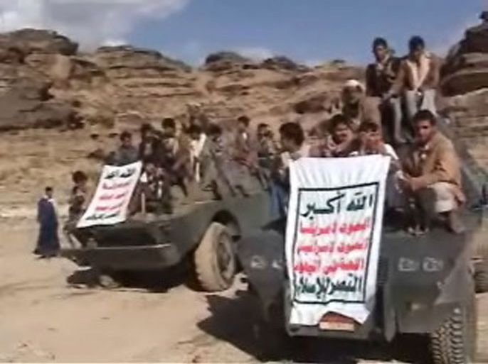 epa01840510 An undated video grab distributed on 28 August 2009 by the office of Abdel Malek al-Huthi, the leader of Yemen's Zaidi rebels, allegedly shows members of the group, that is also known as al-Huthis. They are posing with their guns atop military vehicles which they allegedly seized from the Yemeni army during battles the northwestern Saada province. EPA/AL-HUTHI GROUP HANDOUT BEST QUALITY AVAILABLE