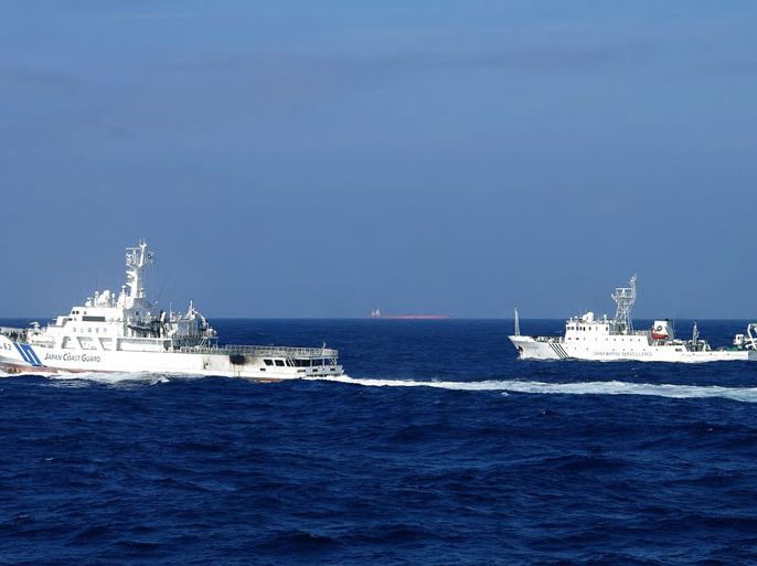 This handout picture taken by the Japan Coast Guard on February 4, 2013 shows a Chinese marine surveillance ship (R) alongside a Japan Coast Guard ship near the disputed islets known as the Senkaku islands in Japan and Diaoyu islands in China, in the East China Sea. Two Chinese government ships on February 4 entered waters around the Tokyo-controlled islands that Beijing claims as it own. Beijing has repeatedly sent ships to the area since Japan nationalised some islands in the chain in September.
