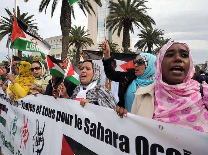 Supporters of the Polisario Front separatist movement hold a banner reading "All for Palestine, all for Western Sahara" during a demonstration at the closing of the World Social Forum (WSF) on March 30, 2013 in Tunis. AFP PHOTO / FETHI BELAID
