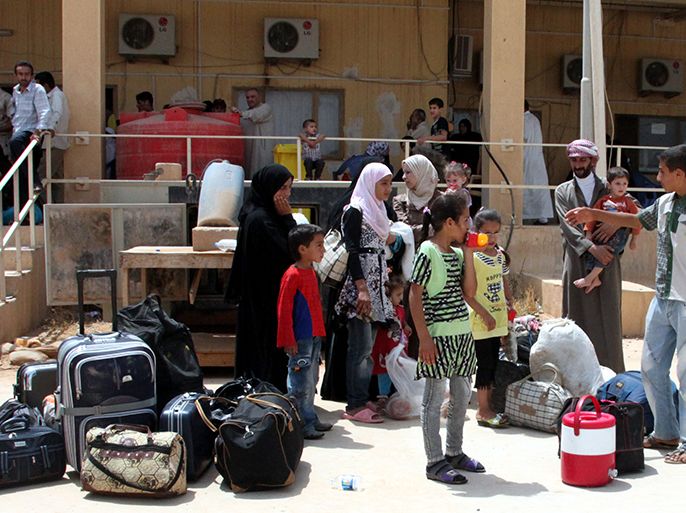 epa03317528 Syrian refugees wait with their belongings to board a bus after their arrival at al-Qaim Abu Kamal border crossing in Iraqi town of al-Qaim, Iraq, 25 July 2012. According to media reports on 25 July, the United Nations refugee agency said that more than 120,000 Syrian refugees are now registered in Jordan, Lebanon, Turkey and Iraq. Governments in those countries had said they were harbouring many more unregistered refugees, the UNHCR added, stressing that many of these displaced people were dependent on humanitarian aid and donations. EPA/AHMED JALIL