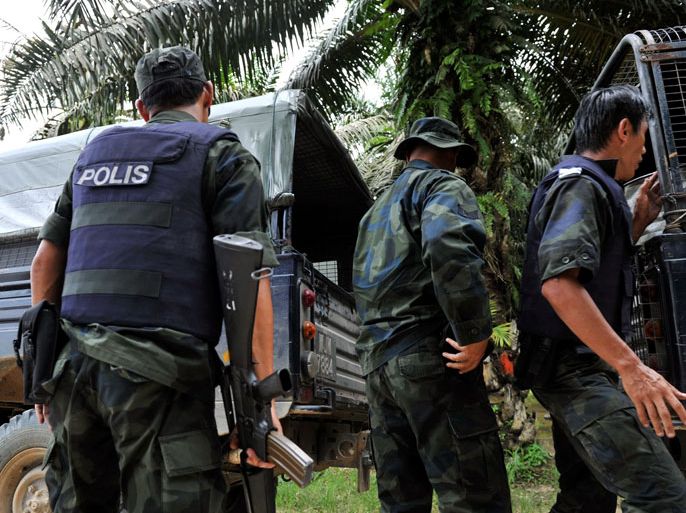 MRN01 - Sabah, -, MALAYSIA : Malaysian Police escort the body of dead police commandos killed in a mortar attack during a stand-off with Sulu gunmen in Tanduo village near Lahad Datu, on the Malaysian island of Borneo on March 1, 2013. Three people including two police officers were killed on March 1 as Malaysian security forces ended a stand-off with Filipino gunmen over a territorial dispute in Sabah, the Philippine government said. AFP PHOTO / BERNAMA NEWS AGENCY