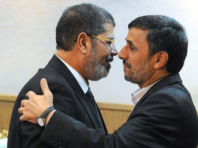 epa03375618 Iranian president Mahmoud Ahmadinejad (R) greets Egyptian president Mohamed Morsi (L) after the opening ceremony of the summit of the Non-Alligned Movement (NAM), the group of countries not aligned wit any of the powers blocs, in Tehran, Iran, 30 August 2012. Iranian Supreme Leader Ayatollah Ali Khamenei opened the Non-Aligned Movement (NAM) summit in Tehran emphasizing Iran's right to pursue a peaceful nuclear programme. The conflict in Syria is also on the agenda of the two-day summit being attended by dozens of leaders from the 120 NAM member states. EPA/SAJAD SAFARI