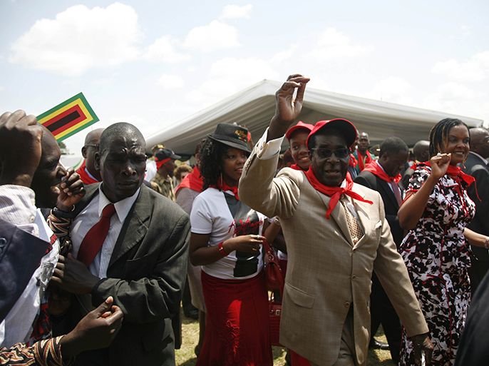 epa03607621 An image made available on 03 March 2013 shows Zimbabwean President Robert Mugabe (C-R) arriving before addressing thousands of people who attended his 89th birthday party, in Bindura, Zimbabwe, 02 March 2013. Mugabe attacked the opposition Movement for Democratic Change (MDC) for claiming that there is political violence in the country as well as attacking the United States of America envoy to Zimbabwe Bruce Wharton for siding with the opposition. Zimbabwe is due to hold elections in 2013 with the date still to be announced. During the celebrations of the birthday, which actually falls on 21 February, Mugabe was presented five cakes, one of which weighed 89 kilograms. EPA/AARON UFUMELI